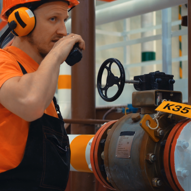 chemical and plastics manufacturing plant employee wearing PPE