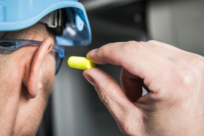 industrial worker using ear plugs